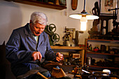 A shoemaker displaying his traditional craft at Lebendiges Museum Odershausen open air museum, Odershausen, Bad Wildungen, Hesse, Germany, Europe