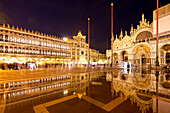 Piazza San Marco with view towards Basilica di San Marco at night with mirror effect, Venice, Italy, Europe