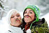 Two young women with fake beards