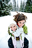 Two young women tobogganing