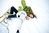 Two laughing young women in snow