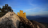 Rocca Calascio castle, in background the Maiella Mountains, Abruzzo Italy, In the sky a hawk flying