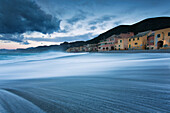 The fisherman village near at the sea in Varigotti town, La Spezia, Liguria, Italy. Beautiful vision of the waves near the house in the beach