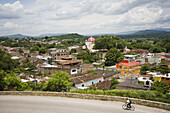 A man bikes past the city of Chiapa de Corzo, Chiapas state, Mexico on June 26, 2008. Large numbers of tourists travel here to visit the nearby Canon del Sumidero.