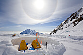 TALKEETNA, ALASKA - JUNE 17, 2008: A sun halo, which is an atmospheric phenomenon, forms over the tents of 14,200 foot basecamp.