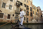 Alexandra Hai, the first woman gondolier in Venice, pilots her gondola through Venice canals.