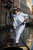 Alexandra Hai, the first woman gondolier in Venice, pilots her gondola through Venice canals.