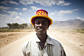 KONSO, OMO VALLEY, ETHIOPIA. A portrait of a young man on a dusty road in the remote areas of the Omo Valley.