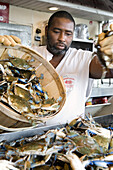 Billy Wise sells crabs at Jessie Taylor's seafood market at Washington, DC's Wharf.  October 2, 2008