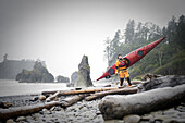 Nick Blakey with a Wilderness Systems Tempest kayak on Ruby Beach, Olympic National Park, Washington, USA, 7 October 2008.