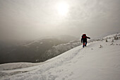 A man hiking on the north end of the Presidential Range and the traditional start of the range traverse.