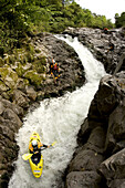 'Dane Jackson running S-Turn while Nick Troutman and Eric Jackson set safety while kayaking the ''Roadside'' section of the Alsaseca River near Tlampacoya, Mexico.'