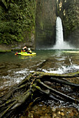 'Eric Jackson, Dane Jackson and Nick Troutman paddling by some roots while on the ''Big Banana'' section of the Alseseca River near Tlampacoya, Mexico.'