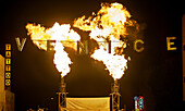 The Venice sign spanning Windwad Ave., is backlit by flames from a live performance during Venice Carnevale in Venice, Calif., on Saturday, June 6, 2009. The annual festival features a variety of live local bands and performers.