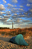 Camping on Cape Lookout National Seashore near lighthouse.  The lighthouse is located on a remote island that is three miles offshore. The island is only accessible by boat and the closest town is Harkers Island, North Carolina.