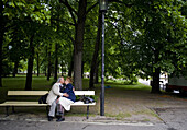 Warsaw, Poland - May, 2009 - Lovers of a certain age kiss inside the grounds of Saxon Gardens, built in the 18th century as the city's first public park. It was modeled on Versailles and is filled with reproduction Baroque statues.