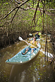 A couple paddling through mangrove channels in Progreso, Yucatan, Mexico.