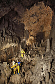 Three British cave explorers move through the main gallary in the classic famous cave in France called The Gouffre Berger high in the Vercors region.