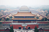 A owerwiew of The Forbidden City in the smug and heatmist of Beijing in july