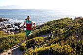 Susann Scheller running on an ocean trail between Gansbaai and De Kelders. South Africa.