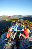 Katrin Schneider and Susann Scheller having a break near Silvermine, while hiking on the Hoerikwaggo Trail from Cape Point to Table Mountain in Cape Town. South Africa.