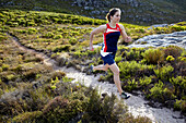 Susann Scheller running on a small trail near Silvermine in Table Mountain National Park. Cape Town, South Africa.