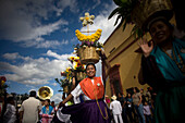 A 'china oaxaquena' dances balancing a basket of flowers on her head in during the Guelaguetza parade in Oaxaca, Mexico.