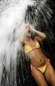 NUQUI, EL CHOCO, COLOMBIA -- DECEMBER 8:  A tourist bathes in a cold rainforest waterfall in Nuqui on December 8, 2005.  Nuqu’ is a small town on Colombia's isolated and untamed Pacific coast, an area sandwiched between endless miles of trackless rainfore