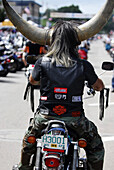A man wears a bull horned helmut while on his motorcycle at Sturgis Motorcycle Rally in South Dakota.