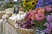 An assortment of flowers and produce overflow the markets of Aix-en-Provence, France.