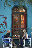 Two women chat while having a beer in Buenos Aires, Argentina.