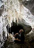 Pretty cave formations called Stalactites and Straws in a small passage in Whiterock part of the giant Clearwater Cave System, in Mulu National Park
