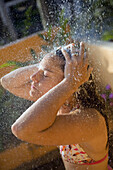 Young woman, Kristi Lloyd, cools off on a hot day after going to the beach in Sayulita, Mexico.