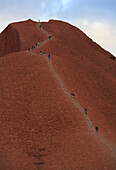 ULURU, AUSTRALIA - JULY 20: People make their way up the large monolith rock Uluru at  Uluru - Kata Tjuta National Park in the Northern Territory of Australia, July 20, 2006. The rock, also known as Ayers Rock, is owned by the aboriginal people in the are
