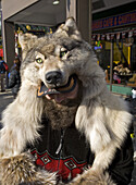 A man wearing a wolf fur jacket in Anchorage at the Iditarod dog sled race starting line festivities, Alaska.