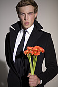 SMASHBOX STUDIOS, CA - JANUARY 15: Male model Philip Roberts holding flowers during a photo shoot at Smashbox Studios, California on January 15, 2007. Photo by Olivier Renck/Aurora