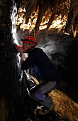 Cvae explorer Tim Allen leans into an underground stream of water to quench his thirst in Moon Cave in Mulu National Park in Sarawak Borneo, February 2, 2007. Tim Allen was part of a group of British explorers that mapped an additional 26 kilometers of th