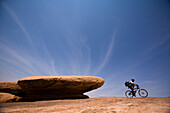An unknown racer rides by during the mountain biking leg of day five of the 2006 Primal Quest adventure race in Moab, Utah.  It was the largest expedition adventure race ever held with 95 co-ed teams of four covering 400 miles in 5-10 days in hopes of win