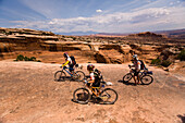 Silly Rabbits team members ride by during the mountain biking leg of day five of the 2006 Primal Quest adventure race in Moab, Utah.  It was the largest expedition adventure race ever held with 95 co-ed teams of four covering 400 miles in 5-10 days in hop