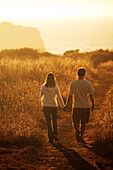 Blair and Jamie Salling hold hands while walking into the sunset in Big Sur, California.