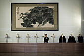 A Chinese attendant operates a coat-check in the Great Hall of the People during a session of the National People's Congress, China's Parliament.