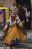 A solitary mask dancer appears wearing a frightening mask and silk brocade. They circle the courtyard with sprightly leaps. Called protectors of faith, or Dharmapdla, the origins of figures like these can be traced back to the pre-Aryan peoples of India. 