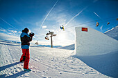 Skier jumping over big kicker in the funpark, Betterpark, Kaltenbach, Zillertal, Austria