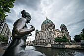 Nude sculpture of woman along the banks of the river Spree facing the Berlin cathedral, Berliner Dom, Museum Island, capital Berlin, Germany