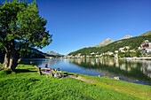 Cyclist resting on a bench at Lake St. Moritz, St. Moritz, Upper Engadin, Kanton of Graubuenden, Switzerland