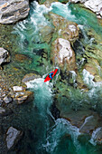 Kayaker on the crystal clear waters of the Verzasca, Ticino, Switzerland