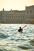 Paddler in front of piazza San Marco on Canal Grande, Venice, Italy