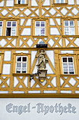 Fachwerkhaus der Engel-Apotheke mit religiöser Wandfigur, Ochsenfurt, Franken, Bayern, Deutschland