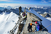 Several persons ascending on ridge to Gran Paradiso, Gran Paradiso, Gran Paradiso Nationalpark, Graian Alps range, valley of Aosta, Aosta, Italy