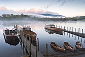 Boats moored on Derwentwater near Friar's Crag in autumn, Keswick, Lake District National Park, Cumbria, England, United Kingdom, Europe